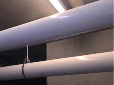 PVC pool heater exhaust & intake piping installation, in parking structure.